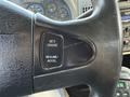 Close-up of the steering wheel of a 2015 International DuraStar 4300 showing buttons for cruise control functionality