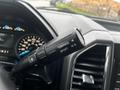 Close-up of the gear shift lever in a 2017 Ford F-150 with settings for Tow/Haul and Sport driving modes