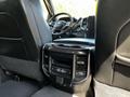 Interior view of a 2022 RAM 3500 showing the back seat and center console with controls and cup holders