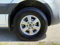 Close-up of a wheel and tire from a 2023 Mercedes-Benz Sprinter showing a five-spoke alloy rim and black tire with a prominent tread pattern