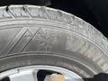 A close-up of a winter tire with a snowflake symbol and the word WINTER prominently displayed on the sidewall