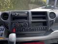Dashboard of a 2018 Hino 195 with controls for air conditioning radio and storage compartments