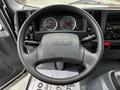 Steering wheel of a 2018 Isuzu NPR with visible speedometer and tachometer gauges on the dashboard