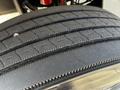 A close-up view of a treaded tire from a 2004 Freightliner M2 showing grooves and patterns designed for traction