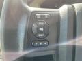 Close-up of the control panel of a 2014 Ford F-350 SD featuring buttons for cycle reset setup info and volume adjustment