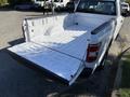 A 2018 Ford F-150 with an open tailgate and a clean, empty truck bed showcasing a white interior finish