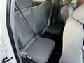 Interior view of the back seats of a 2013 Toyota Tacoma with gray fabric upholstery and seatbelts fastened