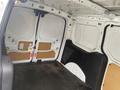 A 2017 Ford Transit Connect interior with open cargo area featuring white paneling and uncarpeted flooring