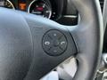 Close-up of the steering wheel of a 2017 Mercedes-Benz Sprinter featuring a multifunction control button with icons for phone and volume adjustment