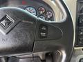 Close-up of the steering wheel controls of a 2011 International WorkStar featuring buttons for cruise control settings