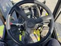 Steering wheel and dashboard of a 2010 Kubota F3990 featuring controls and a digital display