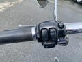 Close-up view of the handlebar controls on a 2008 Harley-Davidson FLSTFI featuring buttons for horn lights and high and low beam settings
