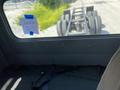 Interior view of a 2008 Peterbilt 340 showing the driver's seat area with a view of the truck's chassis through the window