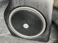 A black Alpine subwoofer installed in the trunk of a car