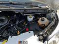 The image shows the engine compartment of a 2022 Ford Transit with various components including the battery and coolant reservoir visible