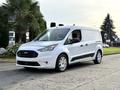 A white 2019 Ford Transit Connect van parked with a sleek design and a sliding side door