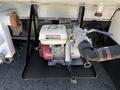A Honda generator mounted on a black metal platform featuring various hoses and fittings connected to it