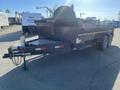 A 2024 Southland 18 Foot Dump Trailer with dual axles and a steel body featuring a front-mounted control panel and a hitch for towing