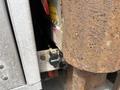 A close-up view of a rusty exhaust pipe with a connected hose and a black Bortail valve on a 2008 Mitsubishi Fuso FE180