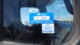 A blue sticker with the text 'BRITISH COLUMBIA CERTIFICATE OF APPROVAL GC 19124 EXPIRES LAST DAY OF MONTH SHOWN JULY AUGUST SEPTEMBER 2024' affixed to a window