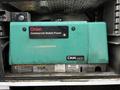 A turquoise Onan commercial mobile power generator model CMM 5500 with visible labels and control panel