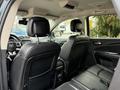 Interior view of a 2013 Dodge Journey showing the backseat area with black leather seats and headrests