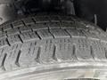 Close-up of a worn tire from a 2020 Nissan NV200 showcasing detailed tread patterns and grooves