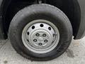 A close-up of a silver wheel and tire from a 2021 RAM Promaster showing the five bolt pattern and tread details