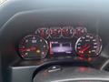 Dashboard of a 2015 GMC Sierra 1500 displaying speedometer and RPM gauge with warning lights illuminated