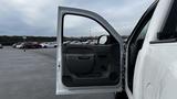 A 2013 Chevrolet Silverado 1500 with its driver's side door open showcasing the interior door panel and handle