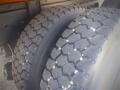 Close-up of two large truck tires showcasing a rugged tread pattern on a 2016 International WorkStar 7500