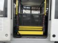 A 2018 Chevrolet Express with a built-in wheelchair lift and a yellow platform lowered for access