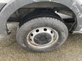 Close-up of a tire on a 2018 Ford Transit showing a black wheel rim and tread pattern on the gray tire