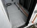 A Huntair Custom Air Handler Unit featuring a metal grate floor with pipes and components visible inside the unit