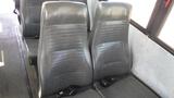 Interior seating of a 2014 Freightliner Thomas Bus Diesel featuring two black leather high-backed seats with seatbelts