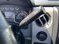 Close-up of the gear shift lever and dashboard controls in a 2014 Ford F-150 highlighting the transmission settings and air vent controls