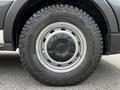 Close-up of a 2022 Ford Transit wheel featuring a rugged tire design and a steel rim