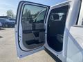 A 2017 Ford F-150 with the driver's side door open showcasing the interior features including seats and controls