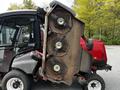 A 2012 Toro Groundsmaster mower with an upright cutting deck featuring three blades and a rusted exterior detail