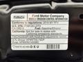 A 2019 Ford Explorer vehicle emission control information label detailing compliance with regulations and fuel type