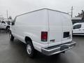A white 2011 Ford Econoline van with a clean exterior and a simple rear design featuring the model name E350