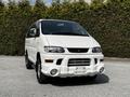 A 2003 Mitsubishi 7 Passenger Van in white with distinctive front styling and a spacious design