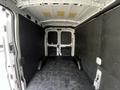 2022 Ford Transit interior view showing a spacious cargo area with black walls and a carpeted floor