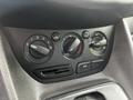 Controls for climate settings in a 2014 Ford Transit Connect including knobs for temperature fan speed and air conditioning