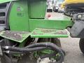 Close-up of a 2009 John Deere 2653B Precision Diesel Mower showing the control panel with a red button and various black hoses attached to the body