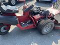 A 2017 Ferries Lawn Mower with a red body black seat and exposed engine components visible on the side