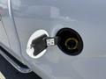 Close-up of a 2014 Ford F-150 fuel cap with the fuel filler neck visible