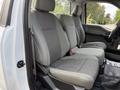 Interior view of a 2018 Ford F-150 showing front seats with gray upholstery and a simple design