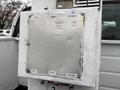 A control panel for a lift or boom attachment mounted on a 2001 Ford F-350 truck showing buttons and indicators for operation