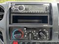 The dashboard of a 2018 Hino 195 featuring a car stereo, an empty radio slot, and climate control knobs for air conditioning and ventilation settings